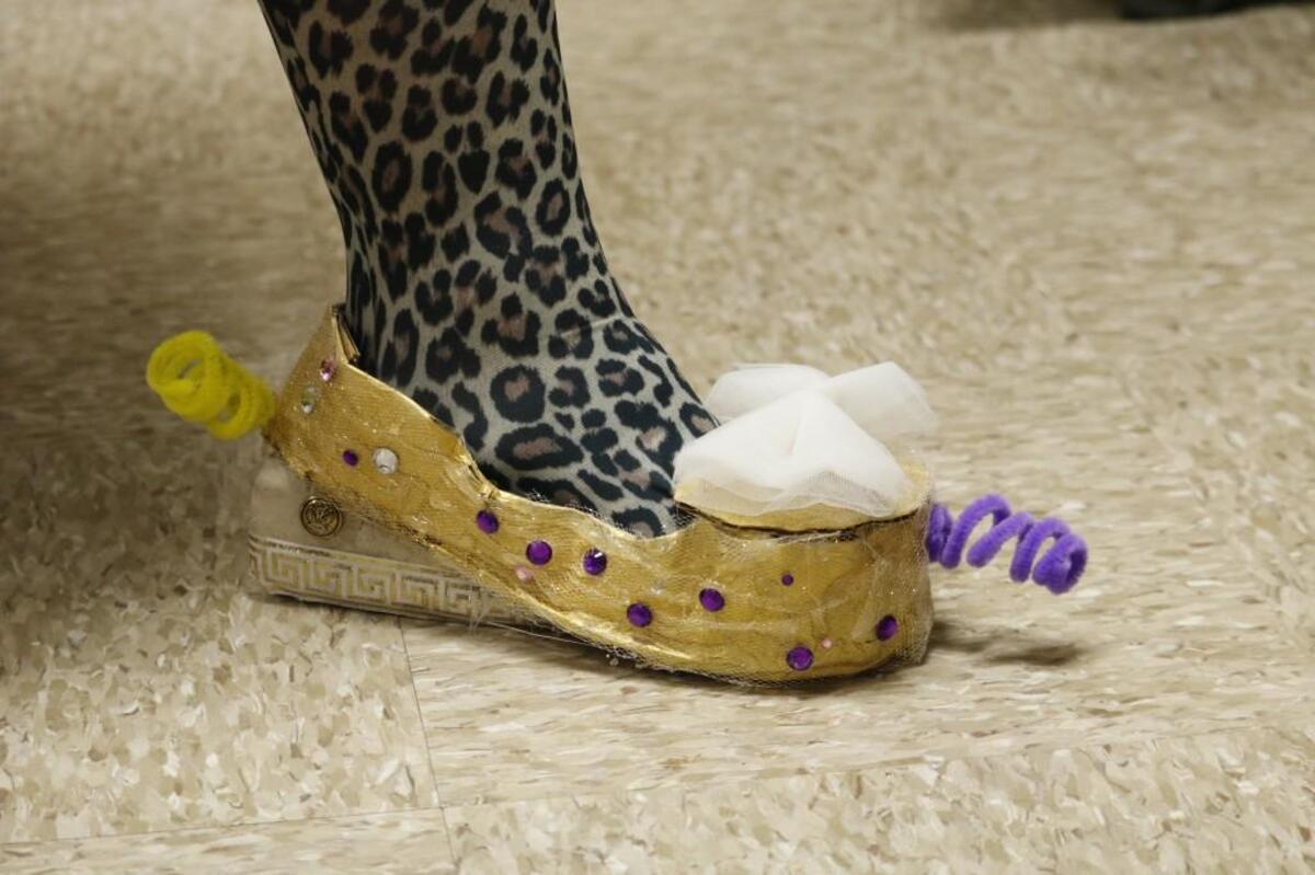 Pam Lewis, director of elementary services for the Shawnee Mission School District, channeled “The Queen Glitter” in her golden shoes Thursday, Jan. 18, 2018, during the Geometry Fashion Show at Rosehill Elementary School in Lenexa.