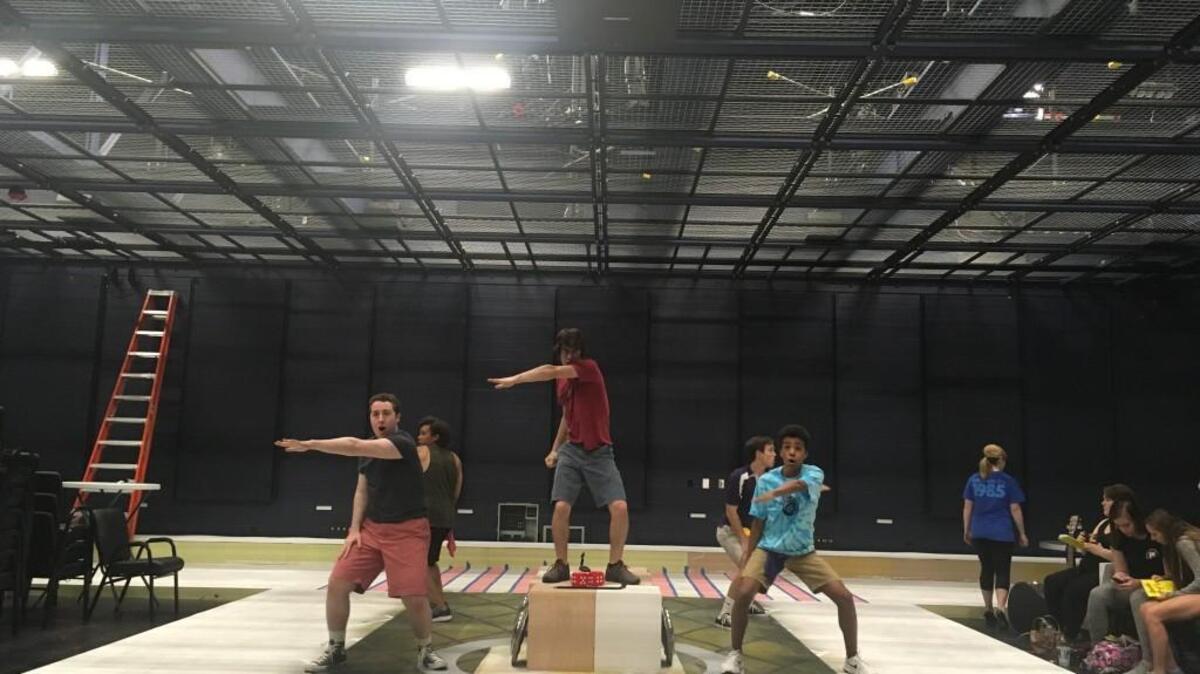 The “Burger Palace Boys” practice their moves at a dress rehearsal.