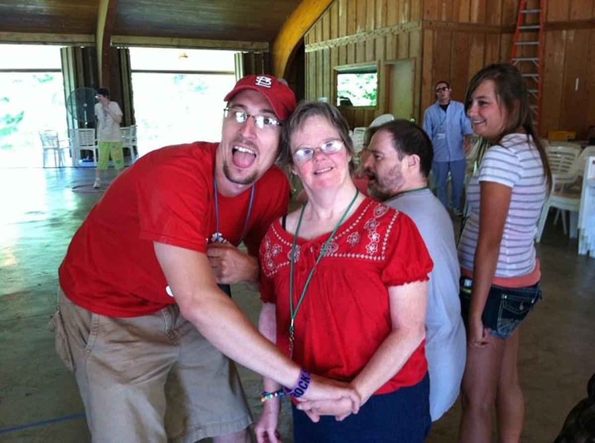 In the summer, Luke Young, a math teacher at Winnetonka High in Kansas City North, works at Camp MOJA in Excelsior Springs. He’s pictured here several years ago at the camp with his aunt, Julie Shackelford. Shackelford, who died three years ago, was his inspiration to work with children and adults with intellectual disabilities.