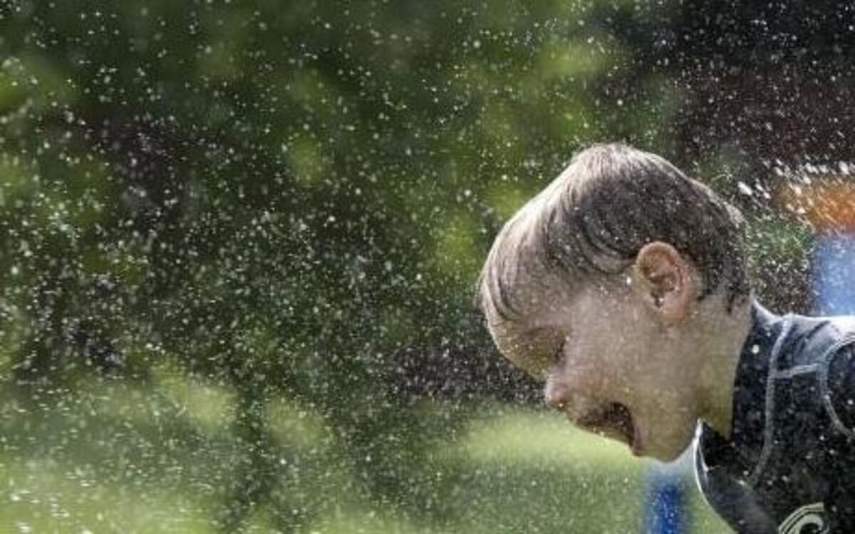 Money saving tip: let the sprinkler do double duty. When the grass needs watering, let the kids play.