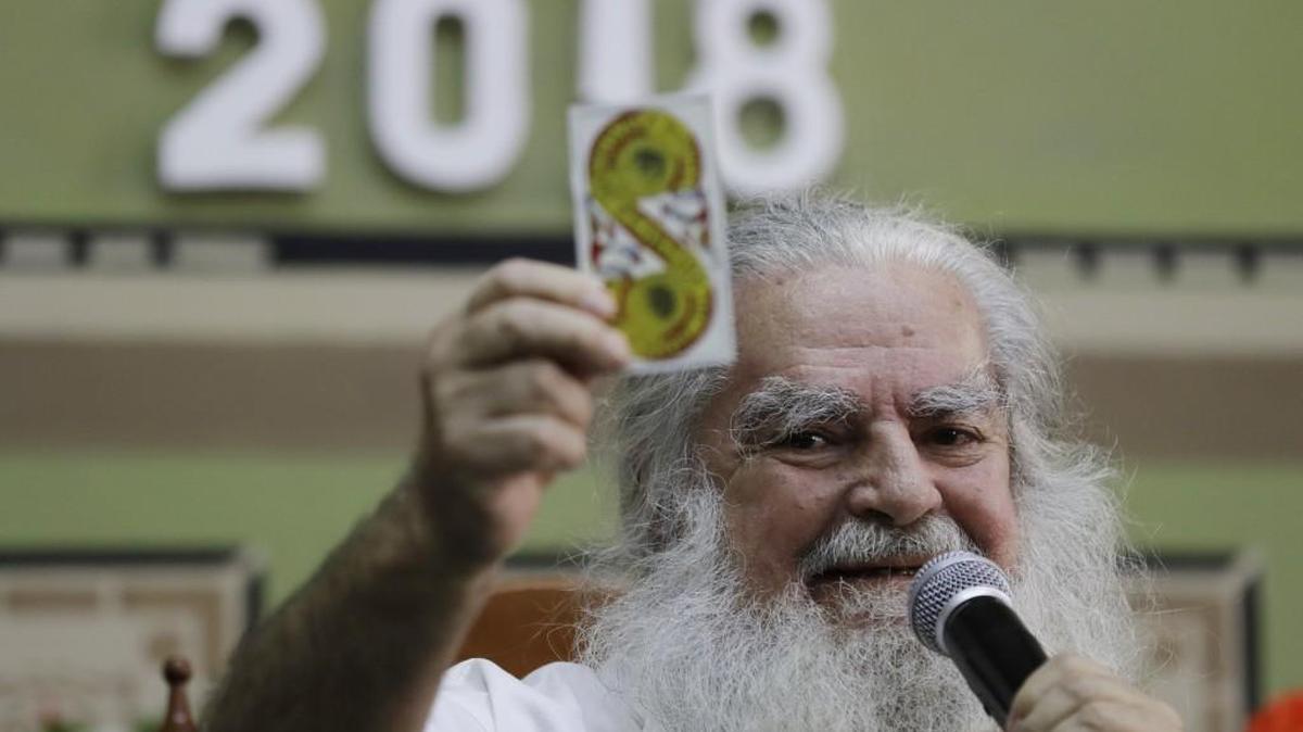 Resolutions, shmesolutions! Who needs them? Certainly not Mexico City’s “Grand Warlock” Antonio Vazquez — shown here holding up a tarot card as he makes his annual predictions regarding politics, sports, and international affairs Jan. 4, 2018, in Mexico City. Despite Vazquez’s consistently incorrect record of prognostication, dozens of journalists gathered at Mexico City’s press club for the Grand Warlock’s latest round of predictions in what has become one of this country’s most reliably strange and inexplicably popular New Year’s traditions.