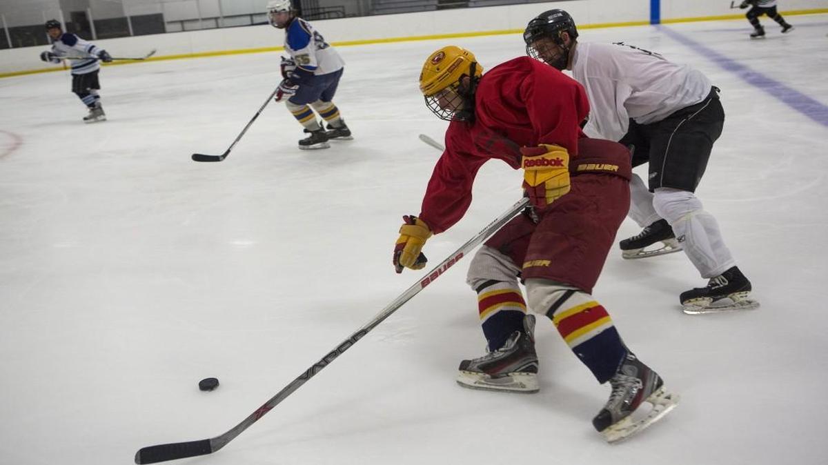 The Kansas City area has three indoor ice rinks that are open all year, including the Kansas City Ice Center in Shawnee. And hockey is a big part of the activity. During a July hockey scrimmage at the rink, Logan Adkins (center) of Shawnee skated past Matt McLin of Olathe.