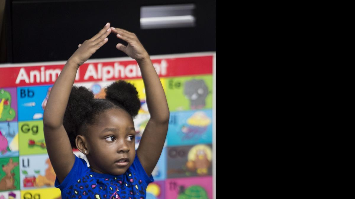 
Rekhia Brown made a "house" as she and her classmates sang "Down by the Bay" at Comanche Elementary during a three-week program to help kindergartners ease into school.
