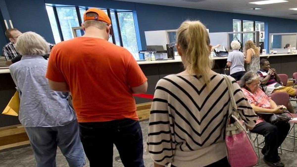 Johnson Countians who register their vehicles next year will pay an extra $5 fee, a ripple effect from the state’s decision to outsource work that had been done at a state office in Topeka. Although the county treasurer’s office handles vehicle registration, the state sets the rules that govern it. Here’s a crowd waiting for service earlier this summer at the Johnson County Motor Vehicle Office, 6000 Lamar Ave. in Mission.