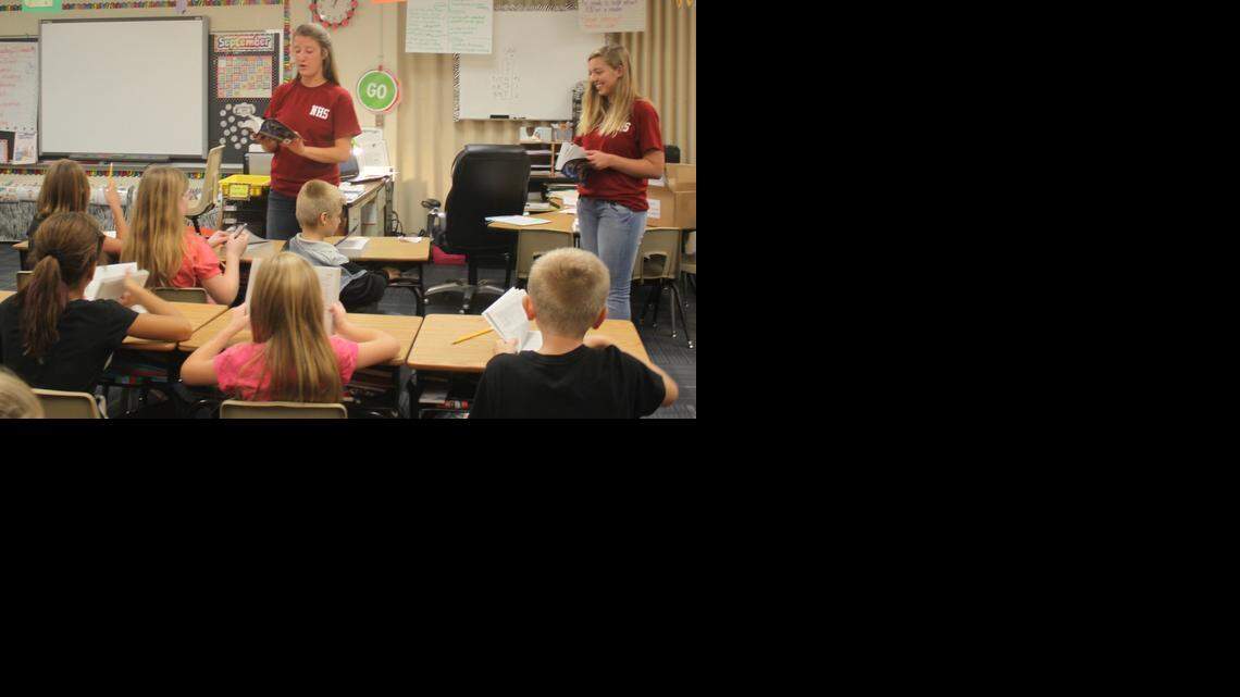 
Representing the National Honor Society at Lee’s Summit North High School, Sarah Welsh (left),and Tori Kelly presented dictionaries to third-graders at Richardson Elementary School in Lee’s Summit. 
