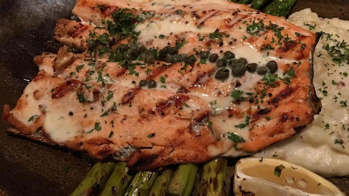 Grilled Freshwater Trout: C. Frogs serves house specialty grilled freshwater trout with roasted red peppers, capers, basil butter, garlic whipped potatoes and grilled asparagus.