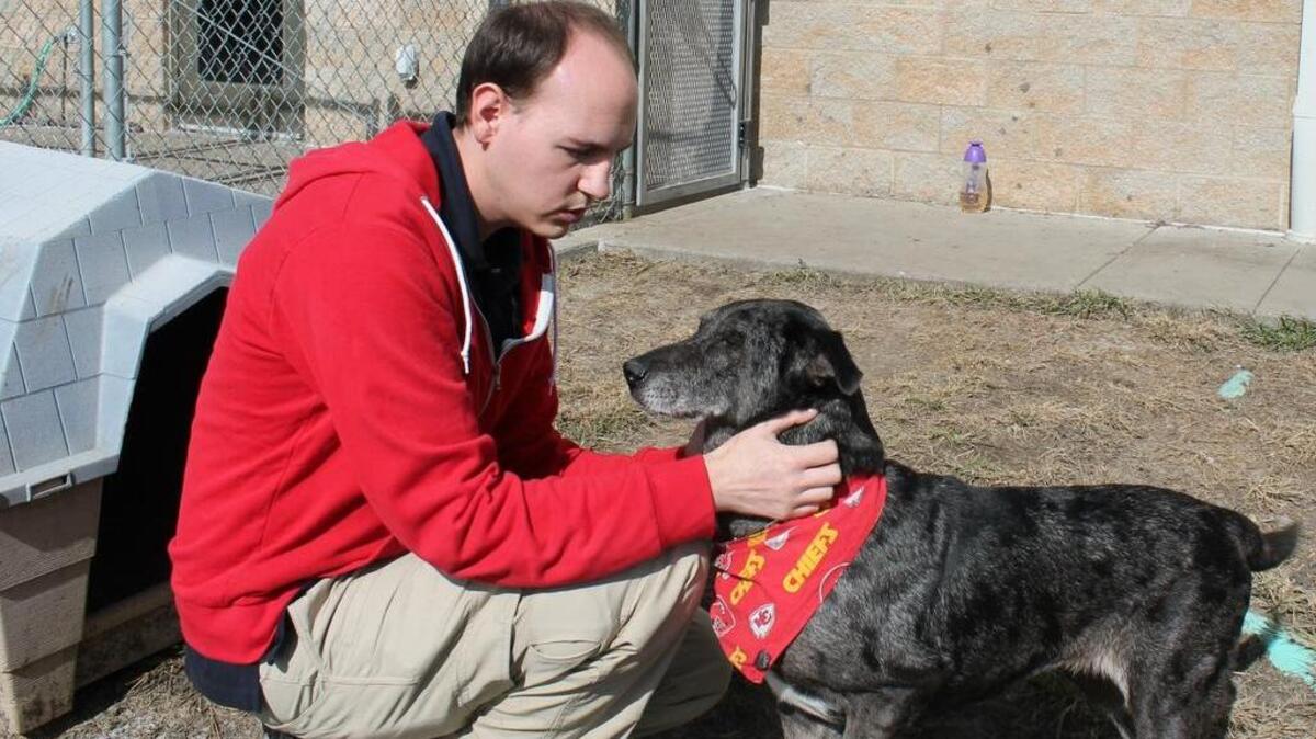 Ben Bailey takes 12-year-old Coco, one of the shelter’s senior dogs, for outdoor playtime.