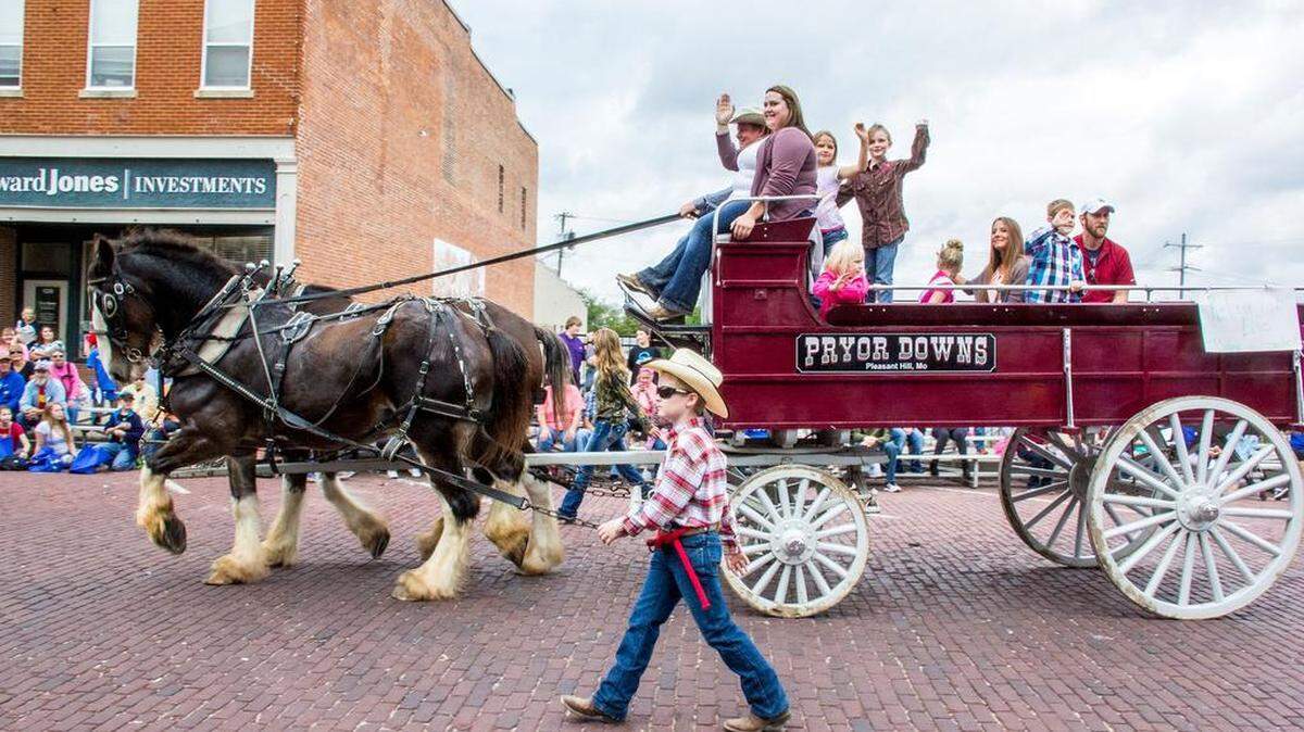 During Harrisonville’s 2017 Burnt District Festival parade, parade participants from Pryor Downs farm, Pleasant Hill, waved to the crowd from the family’s horse-drawn wagon.