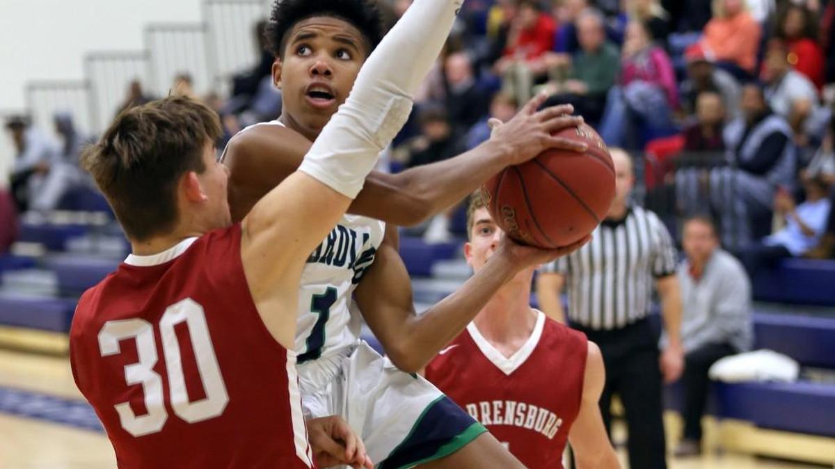 Elijah Betts of St. Michael the Archangel is sandwiched between to Warrensburg player as he looks for a shot during Tuesday night’s game at St. Michael. Betts finihsed with eight points in the Guardians’ 49-44 loss.
