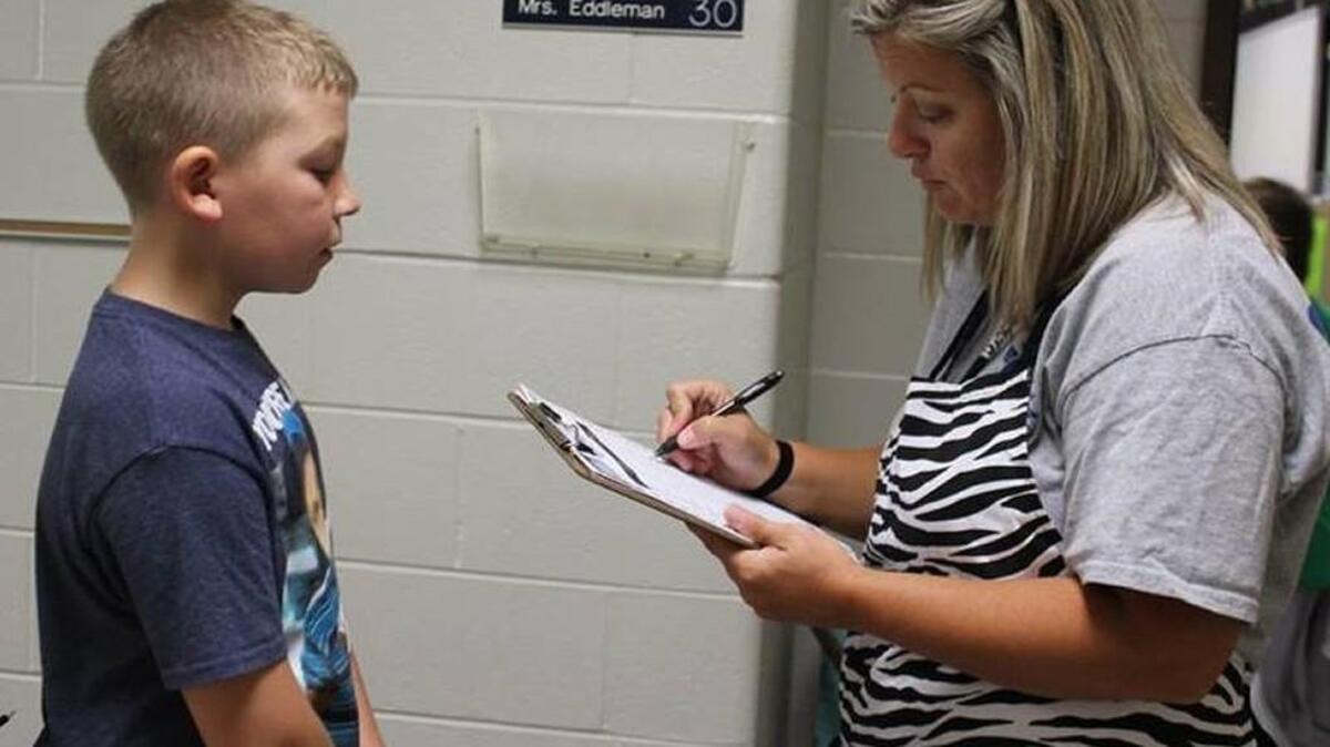 Missy Eddleman greets McEowen Elementary School fourth-grader Bryson Cecil to her literary restaurant.