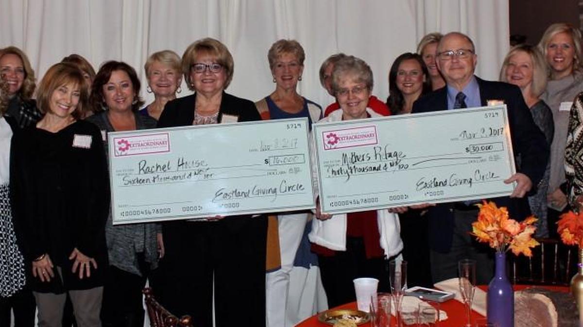 Members of the Eastland Giving Circle posed for a picture with two donation grant recipients — (left, holding check) Rachel House CEO Kathy Edwards and (right, holding check) Susan and Robert Zornes. Robert is the executive director at Mother’s Refuge.