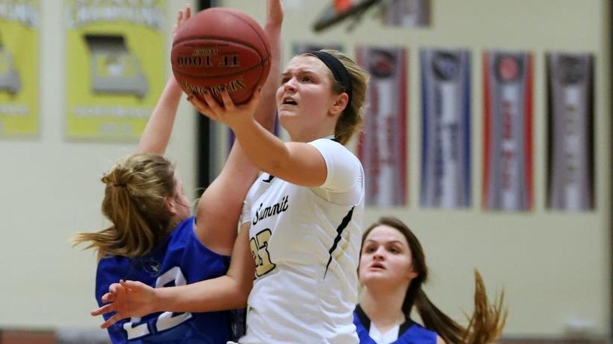Lee’s Summit guard Claire Lock drove between two Liberty defenders, Jillian Fleming (left) and Mary Grace Mason (right), for a layup Tuesday, Jan. 2, 2018, at Lee’s Summit. Lock played for the first time since injuring her knee during the season opener and scored 21 points in the Tigers’ 54-42 loss.