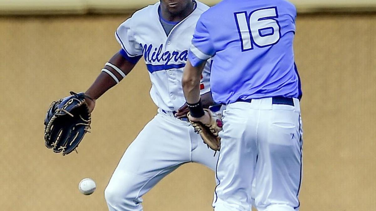 Outfielder Ben McClain (left), a Lee’s Summit West graduate, and second baseman Brigham Mooney chase a ball during the fifth inning of the Ban Johnson League All-Star Game at Kauffman Stadium. McClain played for the Bs, who lost to the Js 7-0.