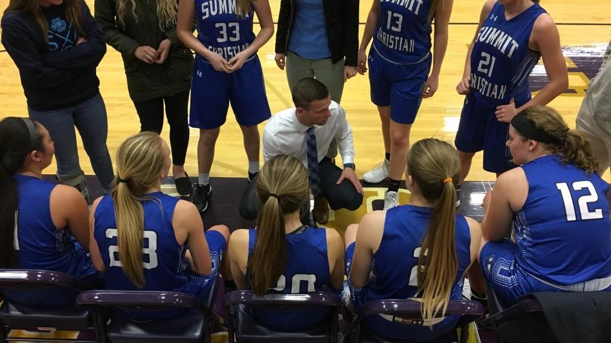 Summit Christian Academy girls basketball coach Chad Friess (center) huddled with his team during a timeout Jan. 12 during the girls’ championship game of the Pleasant Hill Invitational. The Eagles lost to Odessa 44-27 in the final.