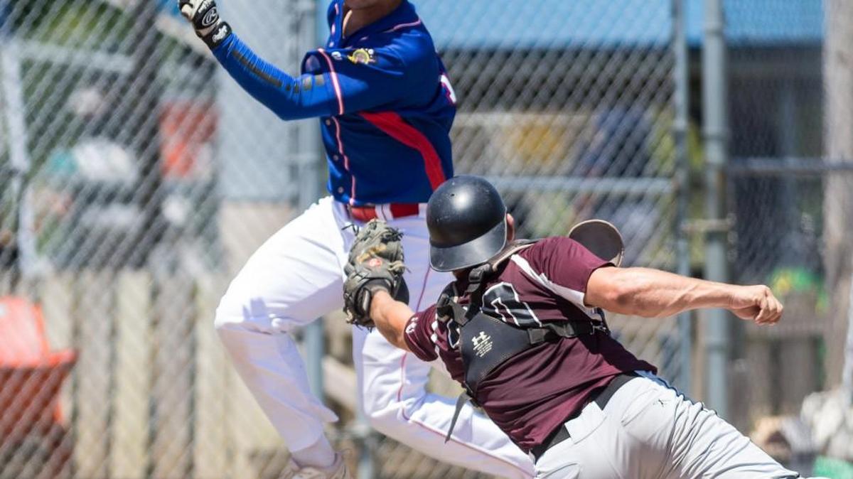 Spencer Hunter of Washington Post 218 eludes the tag of Outlaws catcher Justin McEnroe during the second inning in the American Legion Wood Bat Invitational quarterfinals Saturday. Hunter scored one of Washington’s four runs in the second inning of the Outlaws’ 9-1 loss.