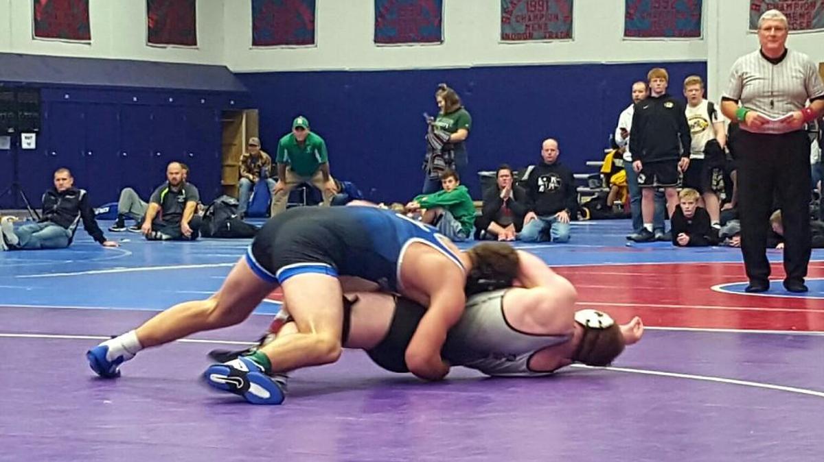 Summit Christian Academy senior Brett Campbell (left) finished a takedown against Knob Noster’s Kodie Bellury during the 195-pound championship match Saturday in the Battle of the Valley Christmas Tournament at Missouri Valley College in Marshall, Mo. Campbell defeated Bellury 10-5 for the title.