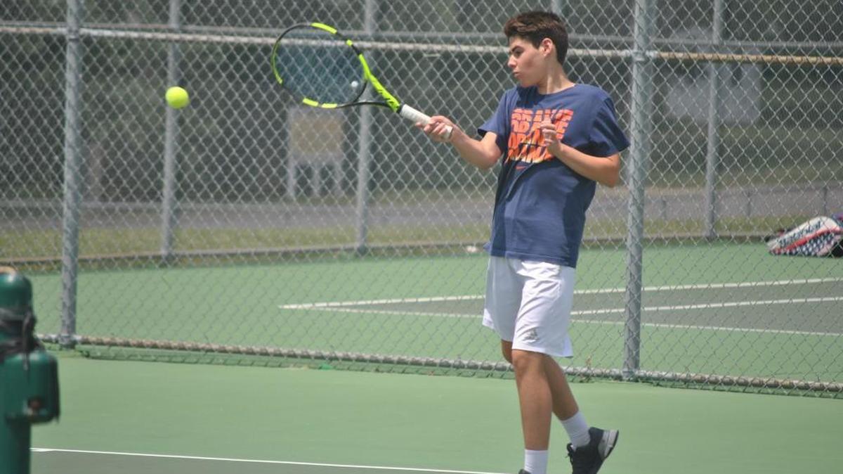 Joe Hammerly of Lee’s Summit North returns a shot while playing Cory Conley of Warrensburg in the third-place varsity boys singles match Wednesday in the Summit Slam at Lee’s Summit North. Hammerly won the one-set match 6-1.