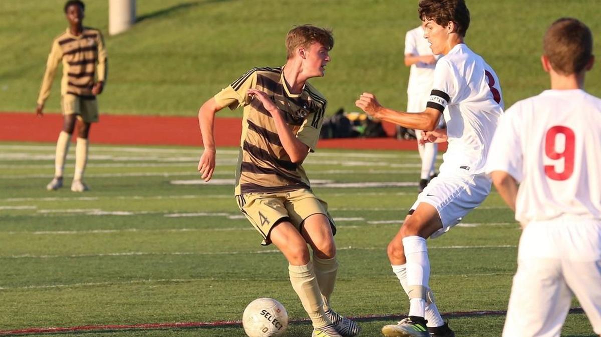 Lee’s Summit North midfielder Kyle Rock (second from the right) and Lee’s Summit defender Ian Shores (left) squared off during a match last season. Rock was recently chosen to the Class 4 all-state first team and Shores was selected as the Suburban Gold Conference defensive player of the year.