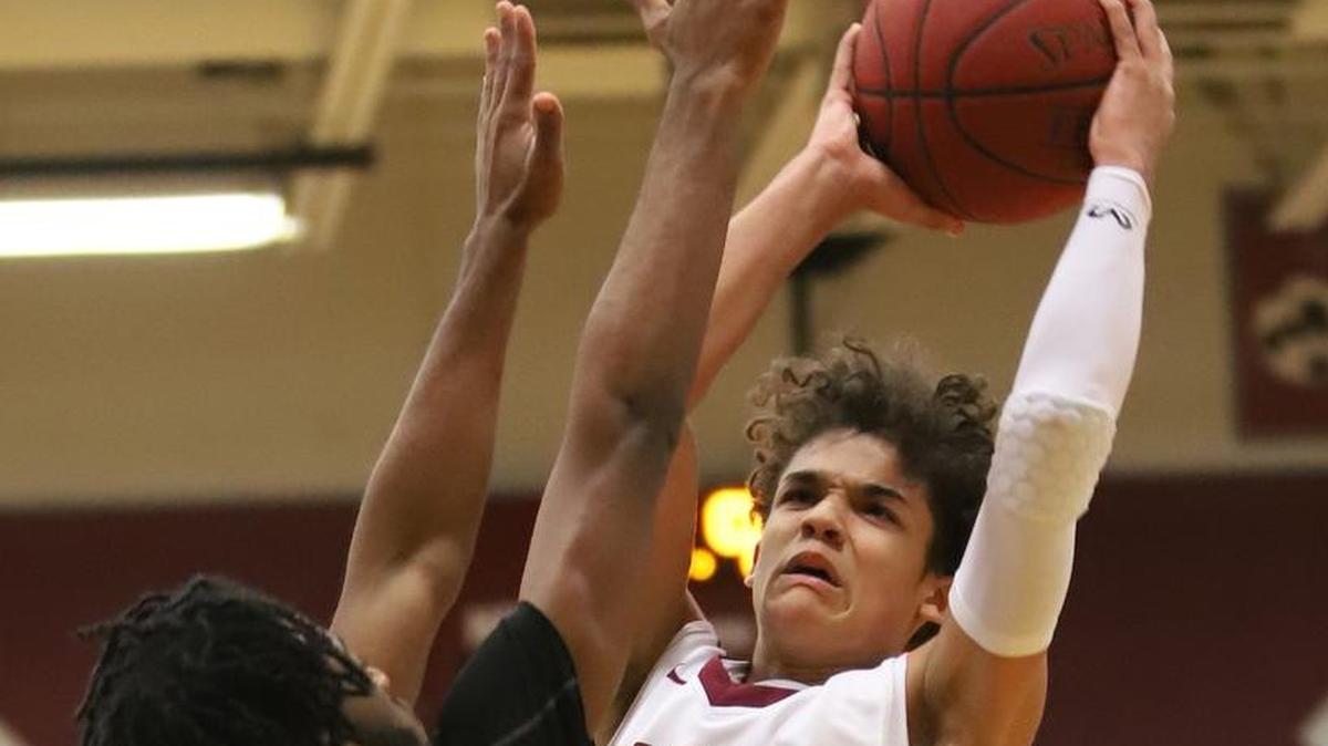 Lee’s Summit North junior guard Javaunte Hawkins (right) shoots over Park Hill South’s Harold Ellis Tuesday during the Broncos’ 70-68 victory at North. Hawkins was injured at the start of the second half and didn’t return.