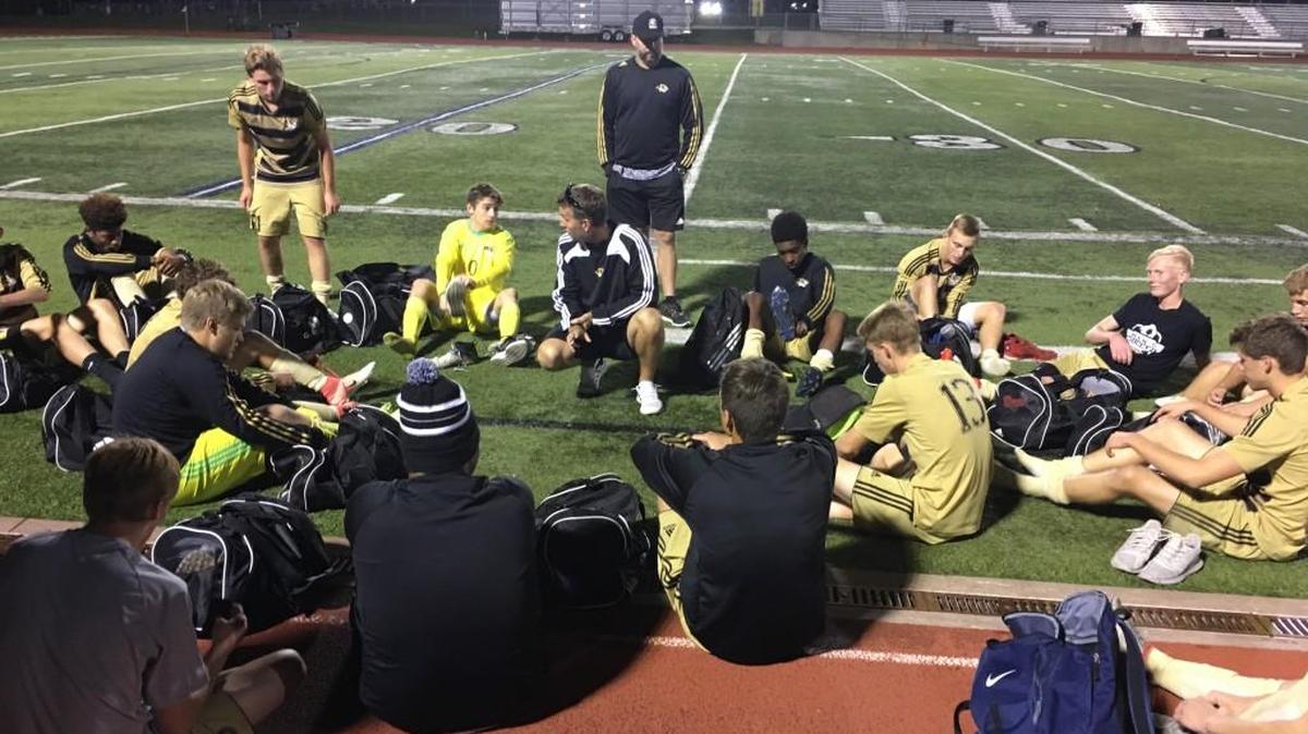 Lee’s Summit soccer players gathered around assistant coach Paul Hawkins on after beating Lee’s Summit West 3-2 in overtime Tuesday night. The two teams meet again Monday in the Class 4, District 12 semifinals.