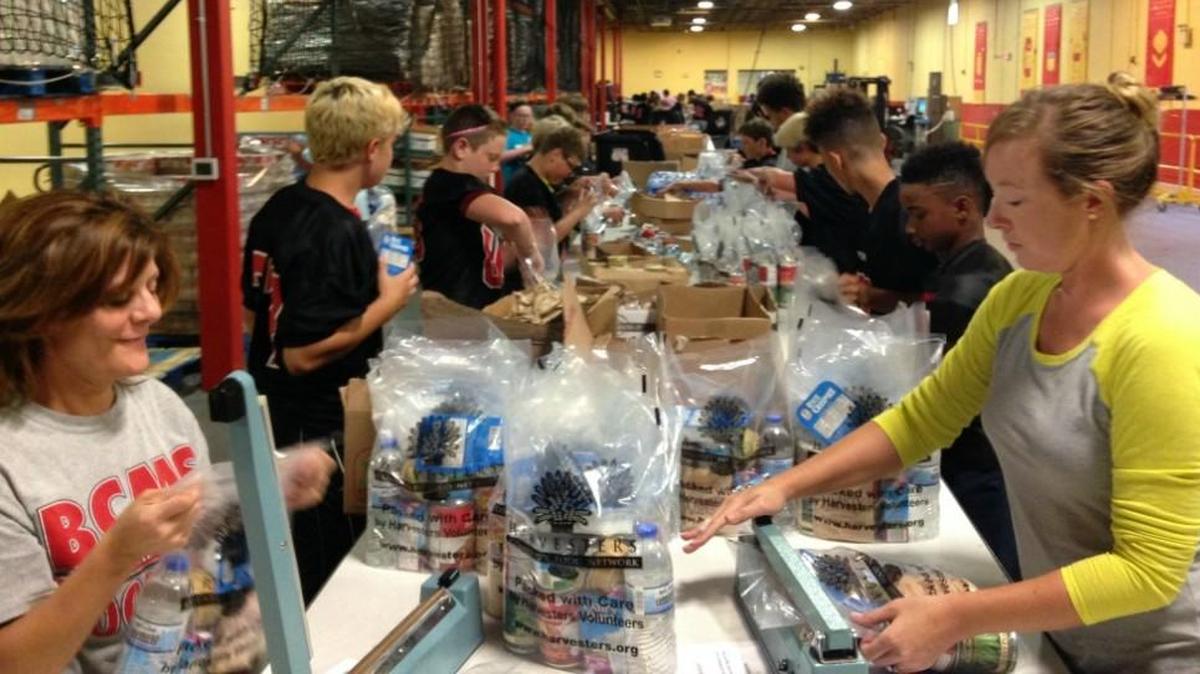 The Bernard Campbell Middle School football team took a day off from practice Oct. 5 to load boxes at Harvesters - The Community Food Network. The boxes contained items for backpacks that are filled with food for students to take home on weekends.