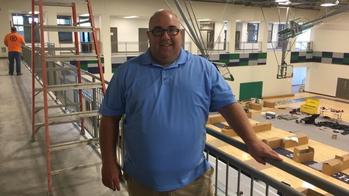 St. Michael the Archangel athletic director Rich Weitz stands amid the construction in the gym as the school prepared to open its doors next month. Weitz, in his athletic director position, has had the task of building the school’s 16 varsity programs from scratch.