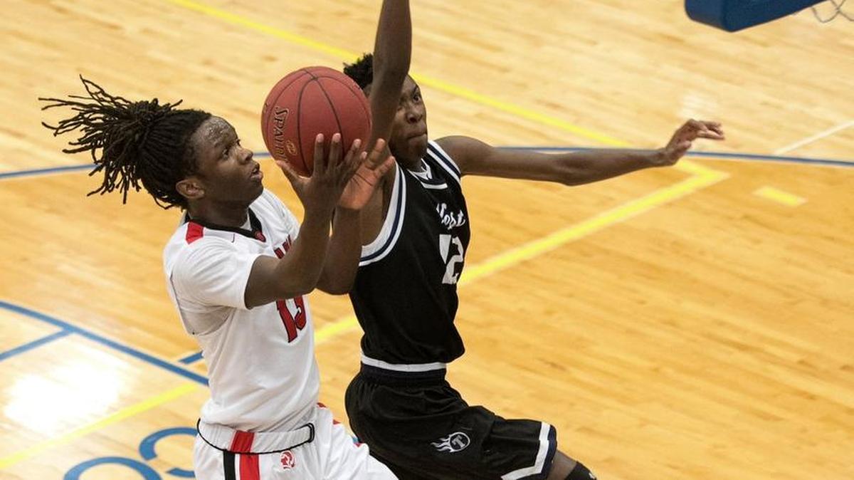 Park Hill’s Teng Akoi (left) went in for a layup against Lee’s Summit West’s Colby Baggett (right) during the C.W. Stessman Invitational boys basketball tournament Friday, Jan. 19, 2018, at Liberty High School.