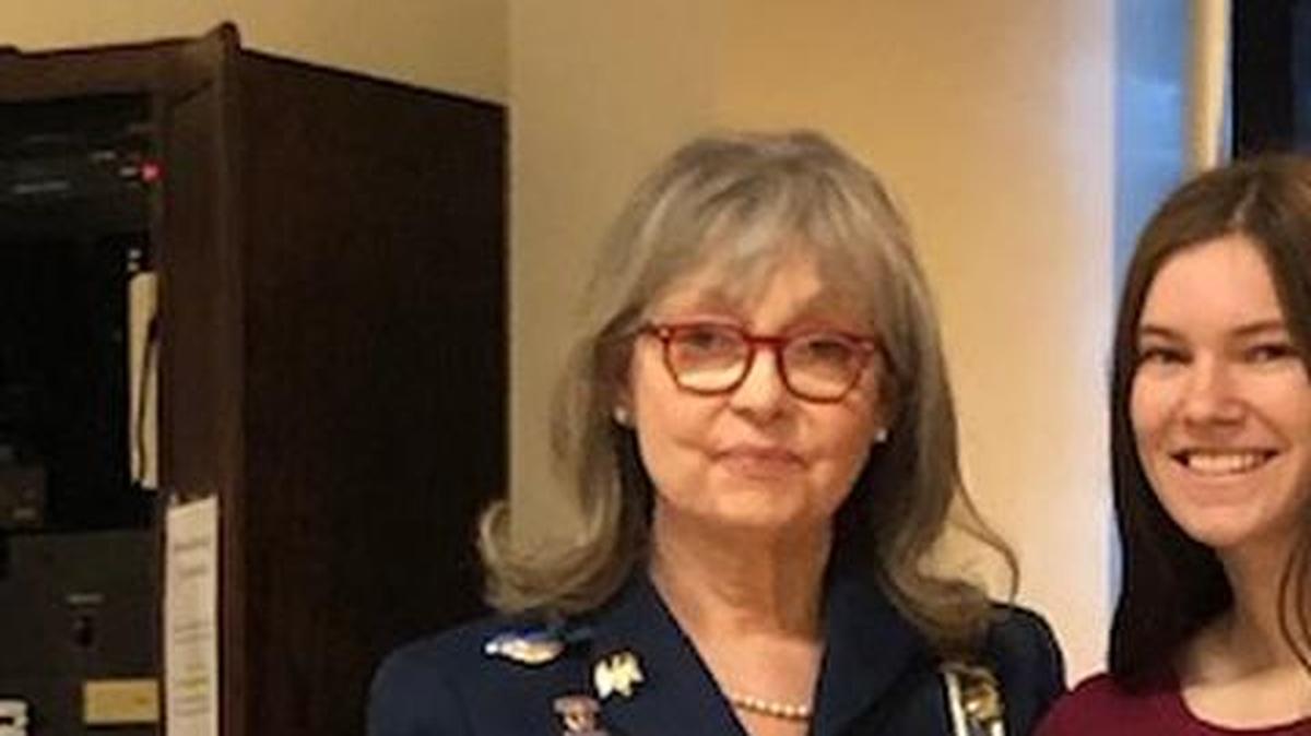 Regent of the Prairie Chapter of DAR, Lucille Lamb, presents a DAR Distinguished Citizen Medal to Rachel Eubank Fossey for her role in helping save a life by performing emergency CPR.