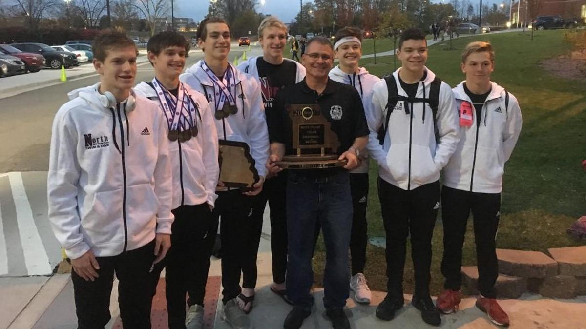 The Lee’s Summit North boys’ swim team shows off its trophy and medals after taking third place during the Class 2 state meet Saturday, Nov. 4, in St. Peters, Mo. The Broncos won three individual events and one relay, placing six of their seven swimmers in the finals.
