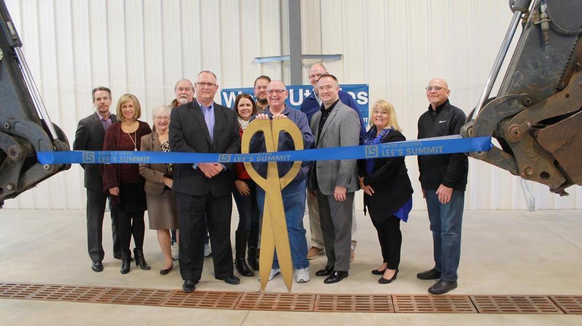 Lee’s Summit Mayor Randy Rhoads (holding scissors), Water Utilities Director Mark Schaufler (front row, left), city council members, members of Water Utility Advisory Board, and city staff helped cut the ribbon during the grand opening of the new Water Utilities Service Center on Dec. 15. The new building is located at 1200 S.E. Hamblen Road in Lee’s Summit.