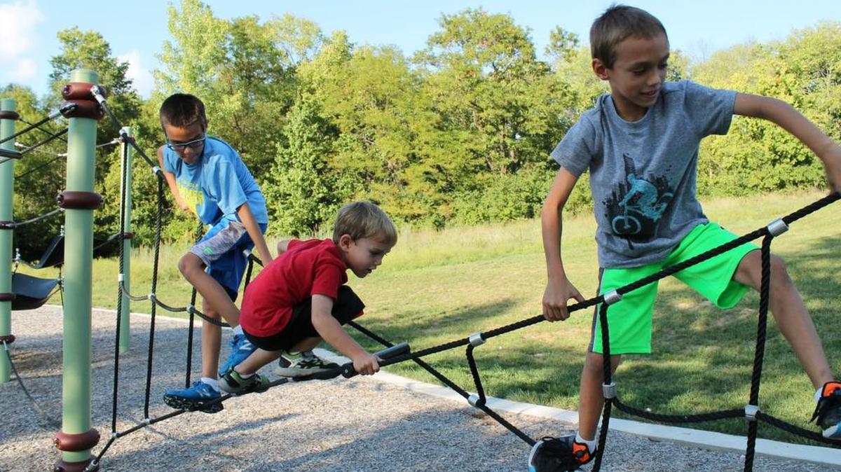 Climbing on the hillside ropes at Hartman Park are, from left, Gavin, Colin and Evan Gloudemans, ages 10, 4 and 7.