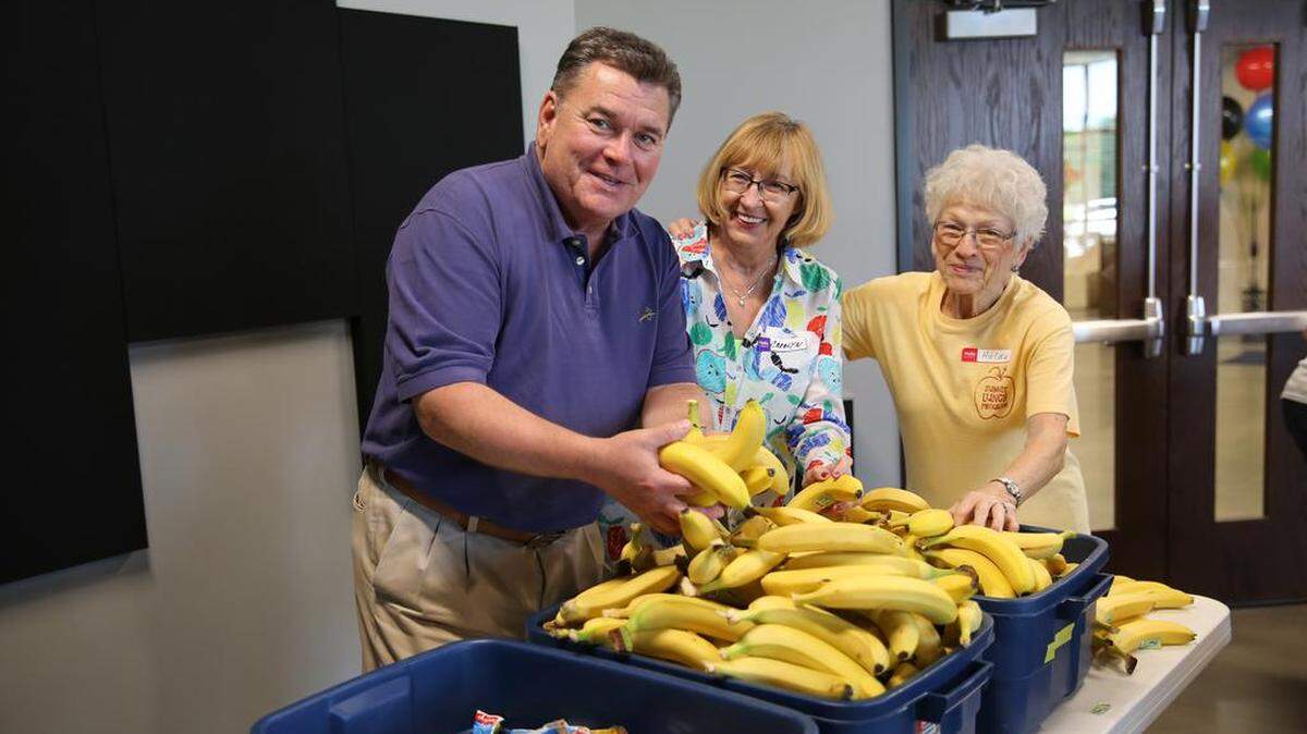 The Summit Church Senior Pastor Jim Preisig and volunteers prepare some of the 250 daily sack lunches sent from the church into the community help make sure children do not go hungry in the summer.