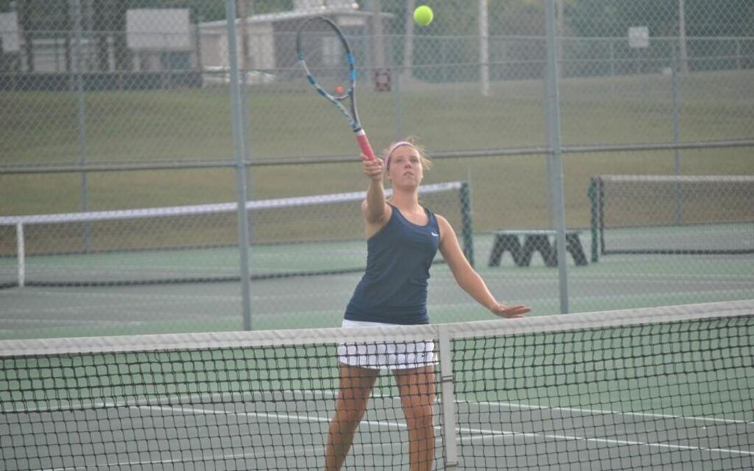 Gillian Evans of Lee’s Summit West hit a smash during her Class 2 girls’ tennis sectional doubles match Oct. 3 at Lee’s Summit North. Evans and Kennedy Cross lost to Miranda Griechen and Mikaela Griechen of Grain Valley 2-6, 7-6 (4), 6-2.