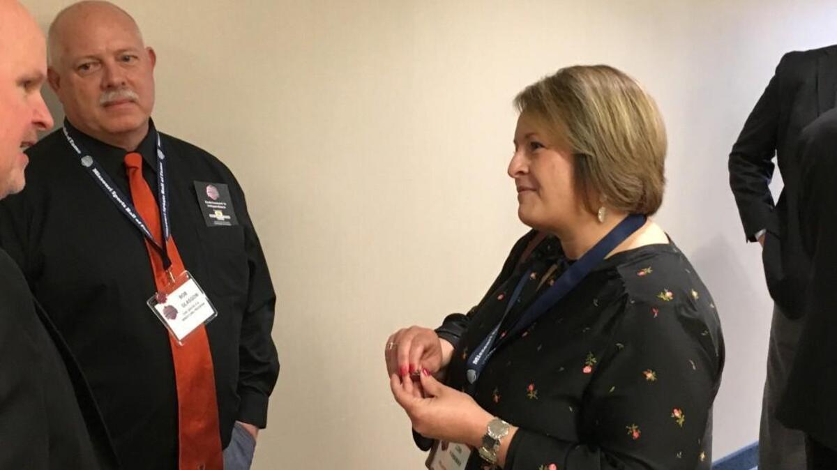 Lee’s Summit volleyball coach Lori Hanaway chats with former Oak Grove wrestling coach Bob Glasgow before the induction ceremony for the Missouri Sports Hall of Fame Nov. 12 in Independence. Hanaway was one of several high school coaches that made up the 16-member class.
