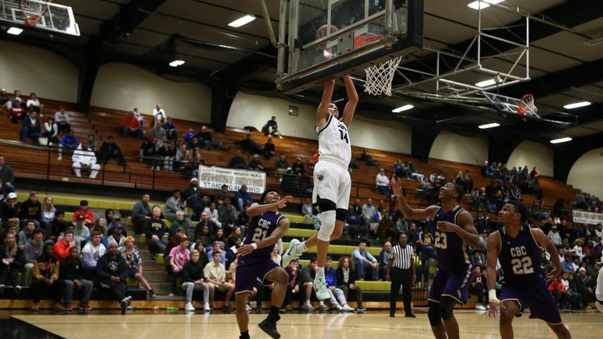 Lee’s Summit West forward Christian Bishop (center) dunked against Christian Brothers College on Saturday, Jan. 13, 2018, during the 810 Varsity Showcase at Lee’s Summit. Bishop finished with 24 points, 14 rebounds and 10 blocked shots — the first triple-double in Titans’ history — during a 59-53 victory.