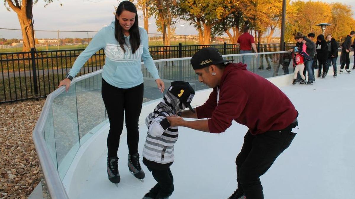 Veronica and Ryan McLain help 5-year-old Jerico McLain circle the ring.