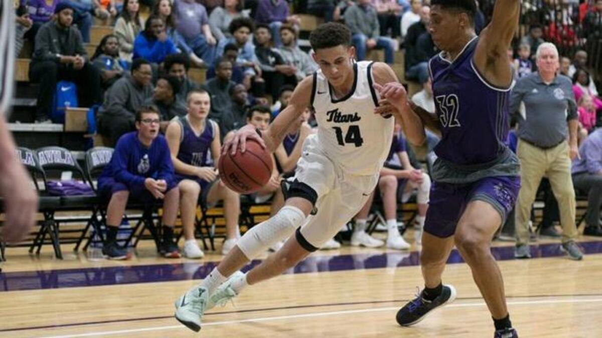 Lee’s Summit West’s Christian Bishop (left) drove the baseline during the Titans’ victory Dec. 16 against Blue Valley Northwest. Bishop scored 20 points Tuesday, Dec. 19, 2017, during a 68-49 home victory against Blue Springs South.
