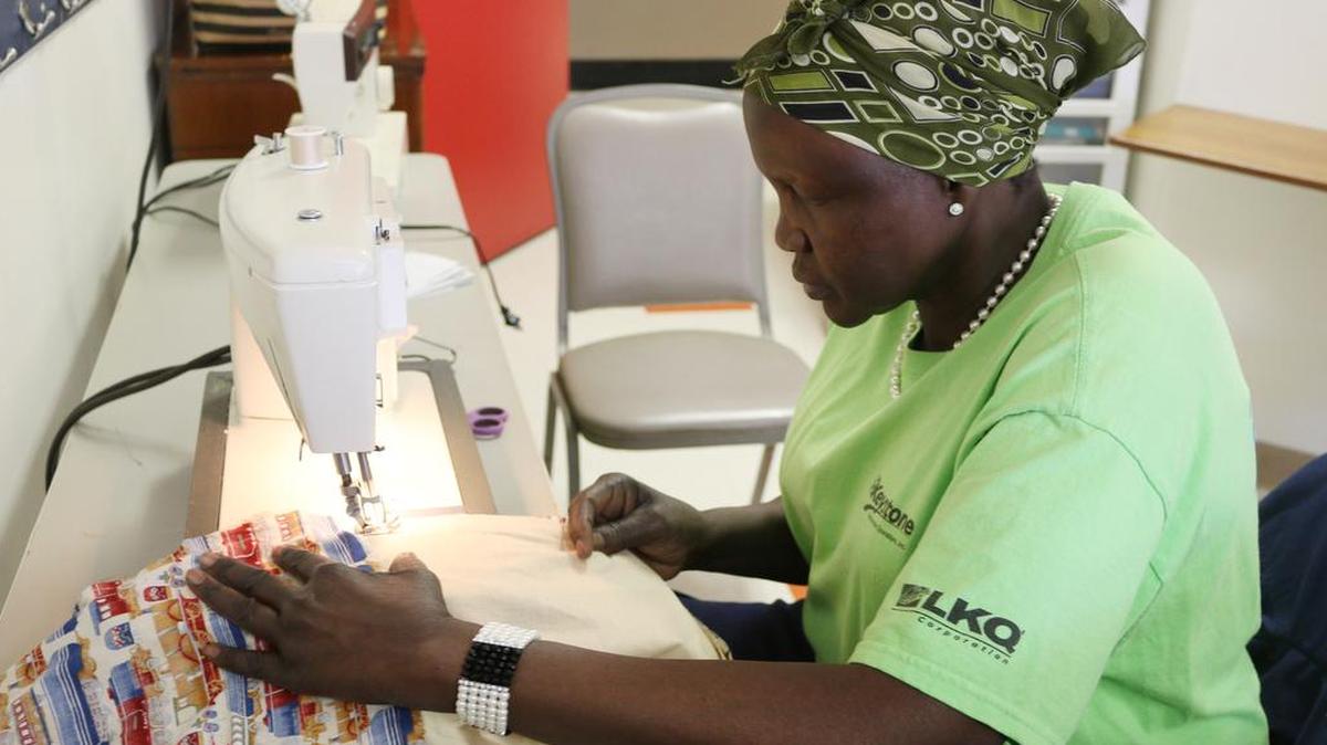 Amer Mbor works on a quilt that will be sent to either a refugee camp or a disaster zone.