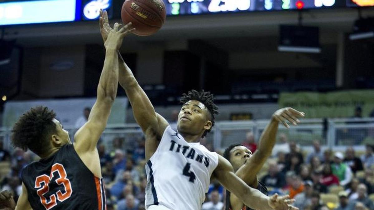 Phillip Brooks (center) and Lee’s Summit West struggled to find any offense against Webster Groves in the Class 5 boys’ basketball state championship game.