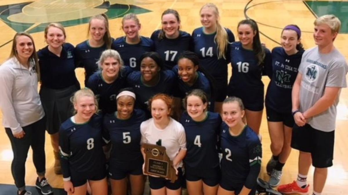 The St. Michael the Archangel volleyball team poses with the first-place plaque after winning the Class 2 District 14 tournament at Barstow. St. Michael, which started the postseason with a sub-.500 record, went on to qualify for the Class 2 state tournament in the program’s first season.