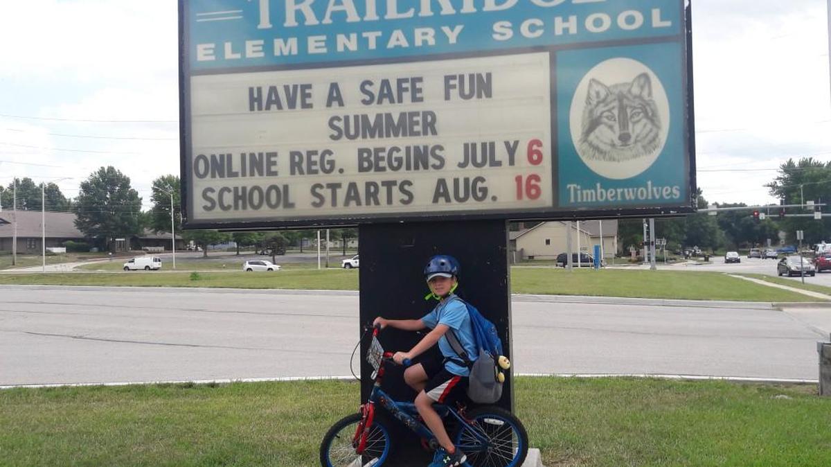 Jason Wichman, 7, rides his bike to summer school.
