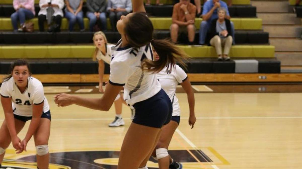 Odyssey Warren of Lee’s Summit West goes up for a hit against Lee’s Summit Tuesday. Warren had eight kills in the Titans’ 25-21, 25-15 sweep at the Tigers’ Fieldhouse.