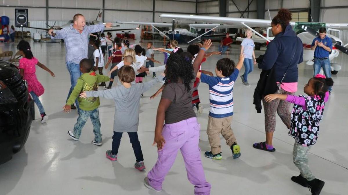 Pilot Austen Plain, the founder of Take Flight Kansas City, entertained a class of kindergartners with his airplane impression Friday, Oct. 6, 2017, during the annual Fly Day field trip at Lee’s Summit Municipal airport. More than 600 kindergartners from the Ervin Early Learning Center also enjoyed an airshow as part of the outing.