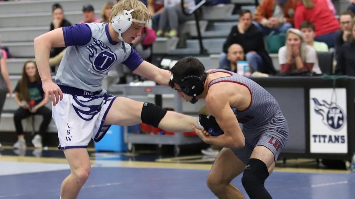 Morgan Potts of Lee’s Summit West (left) tried to escape a leg hold by Lee’s Summit North’s Jaden Duran in a 138-pound division match during Wednesday’s three-way dual at West. Potts beat Duran 4-1.