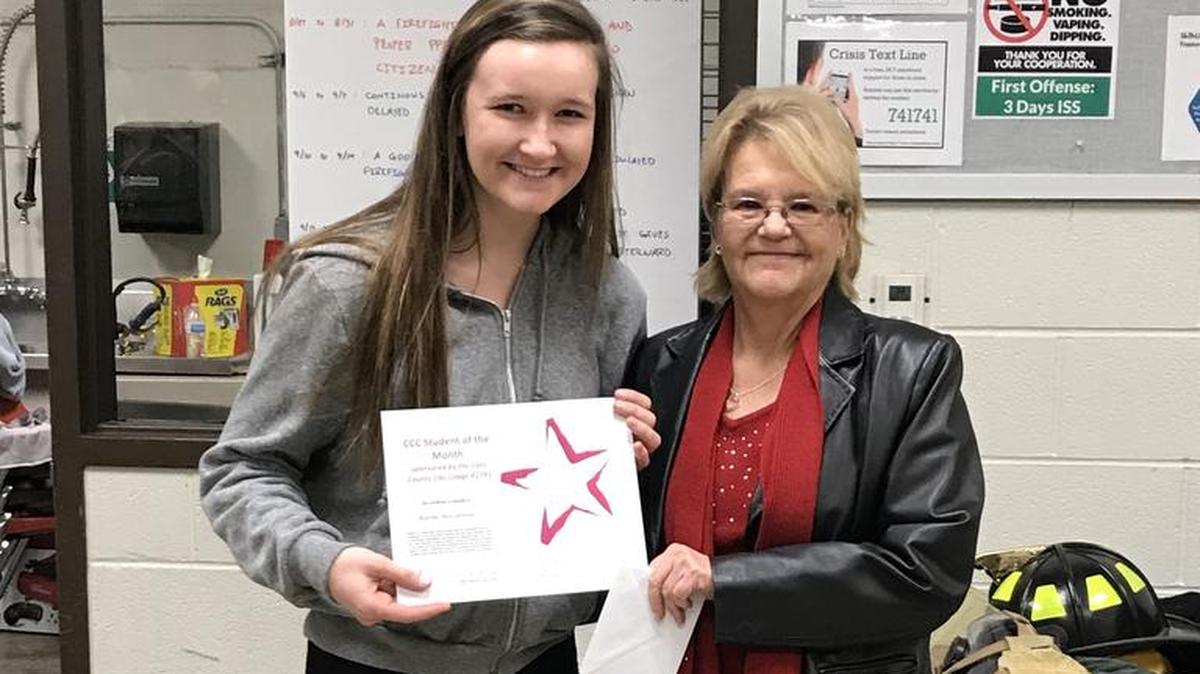 Jeri Ware of the Cass County Elks Lodge presents a certificate and a gift card to Rachel McCommon.