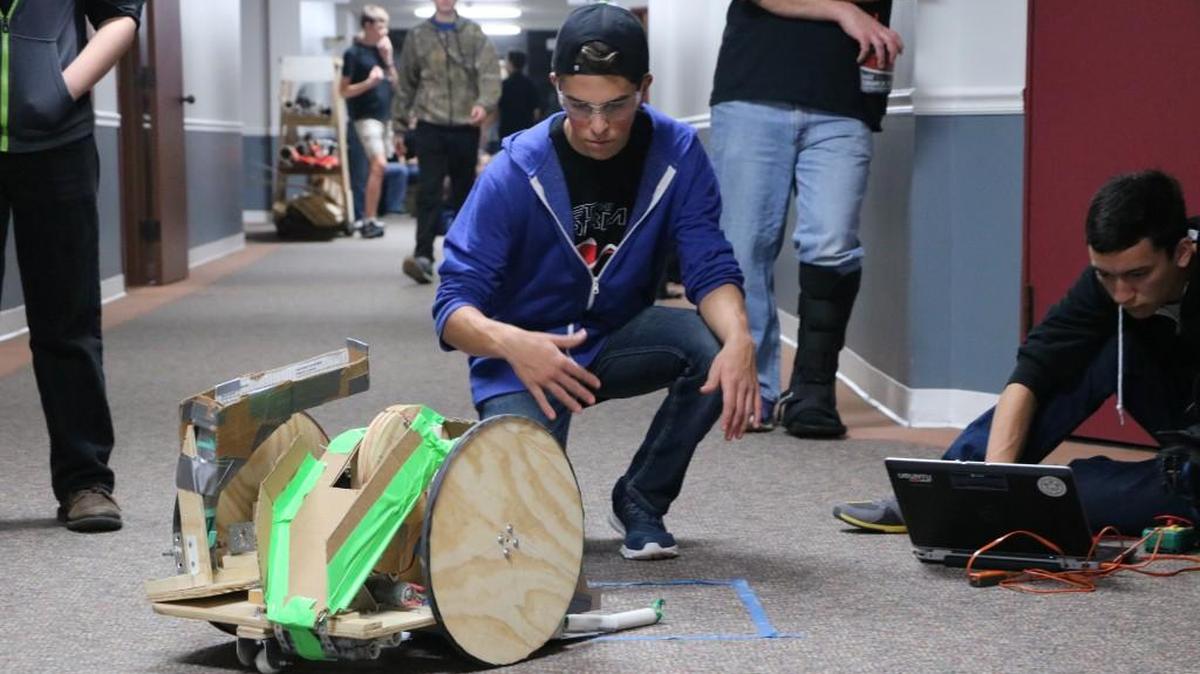 Metro Homeschool Robotics (MHR) team member, Ethan Auch, 15, of Independence, inspected a robot Monday, Oct. 23, 2017, at Lutheran High School in Kansas City. MHR qualified for the the Frontier Trails BEST Regional Championship in December.
