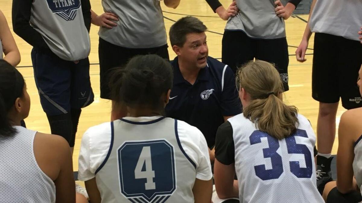 Lee’s Summit West girls basketball coach Jeff Hardin talks with his players after the Titans second scrimmage in a jamboree Wednesday night at West. Hardin said this year’s team is the deepest and most experienced he’s had at West.