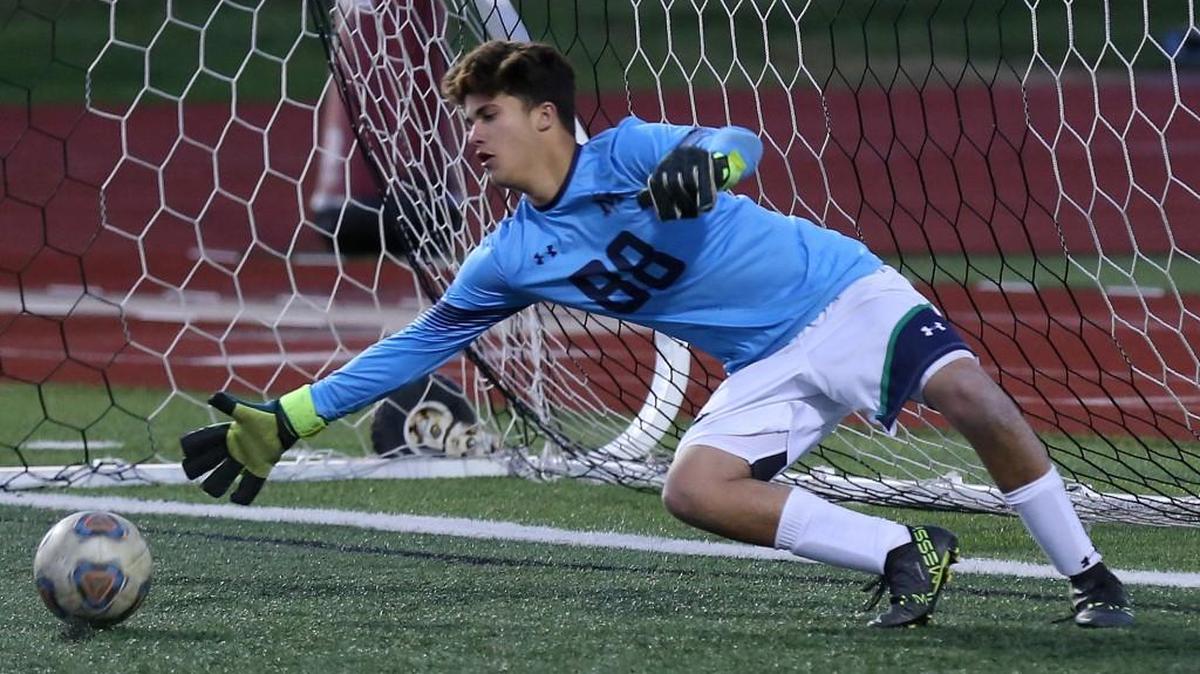 St. Michael the Archangel goalkeeper Vincent Haggerty dives to stop a shot during the Class 2 sectional game against Lincoln College Prep Tuesday at Lee’s Summit North. St. Michael lost 7-0.