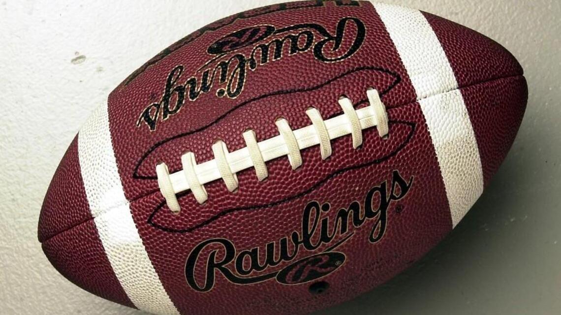 Two Kansas high schools halt football games after one player tests positive for COVID