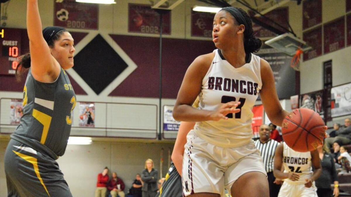 Lee’s Summit North senior post Aiyana Johnson (right) tried to get around Hailey Coleman of St. Teresa’s Academy on Monday, Dec. 4, 2017, in a game at North. Johnson scored 22 points in the Broncos’ 73-60 victory.